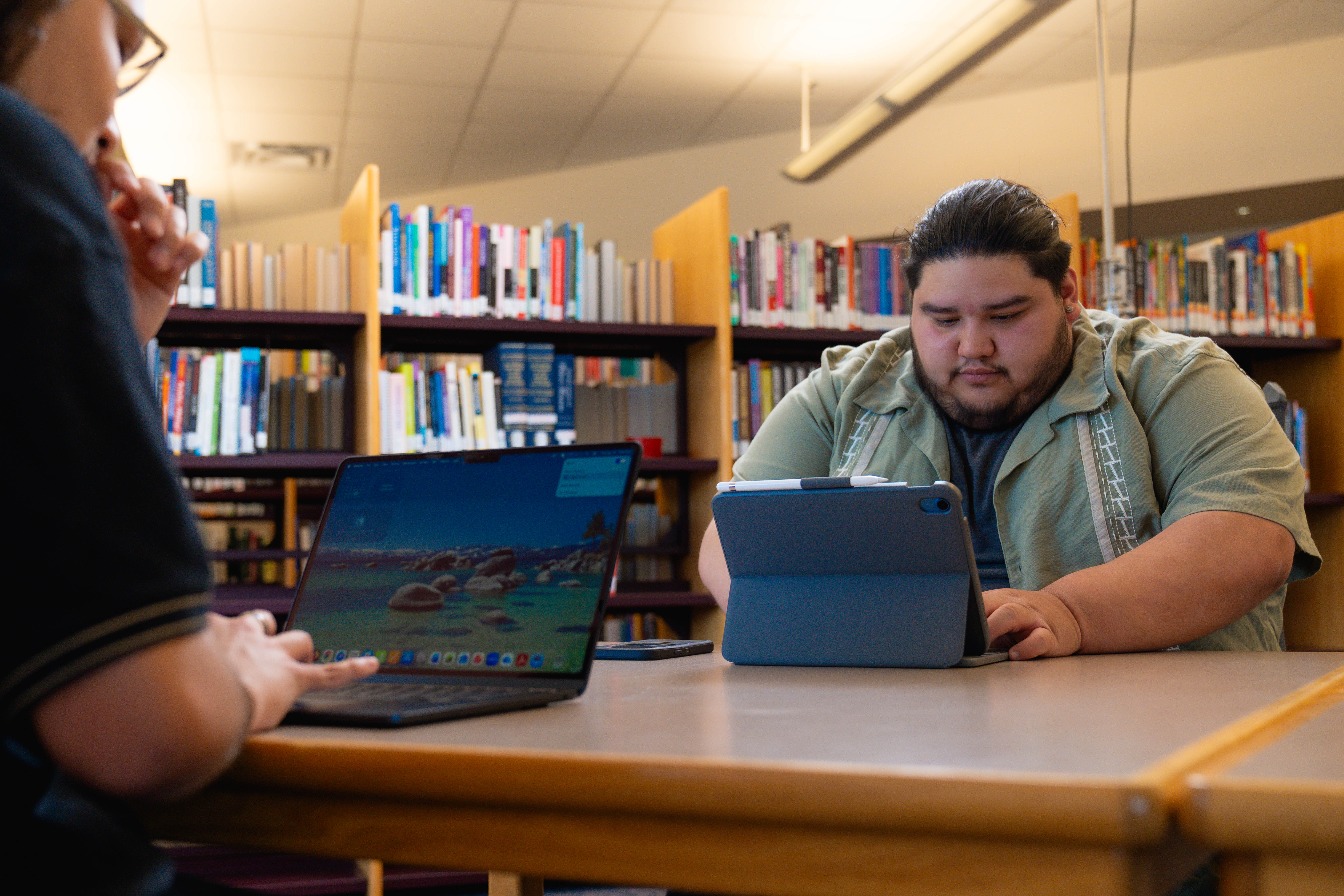 An image of two students working on ipads